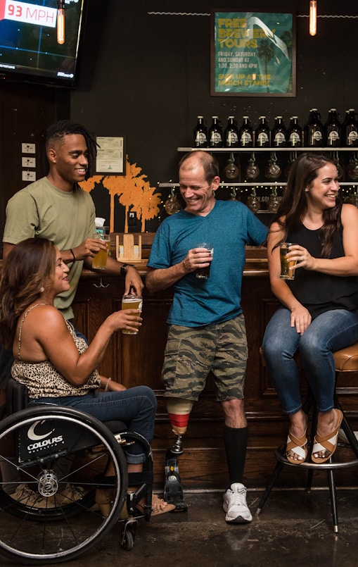 Group of people socializing, including a person in a wheelchair